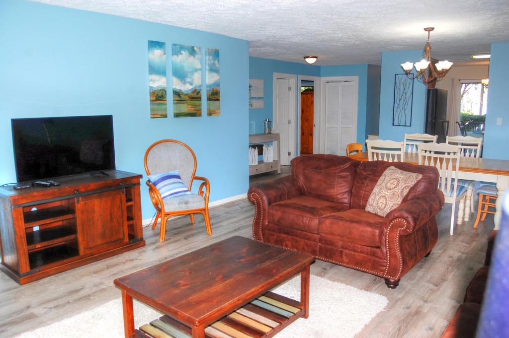 a living room with a couch and a table at Dry Dock 101 in Myrtle Beach