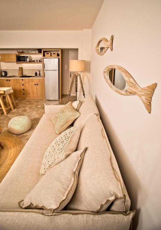 a bed with pillows and a mirror on a wall at Horizon Hotel Kalymnos in Myrties