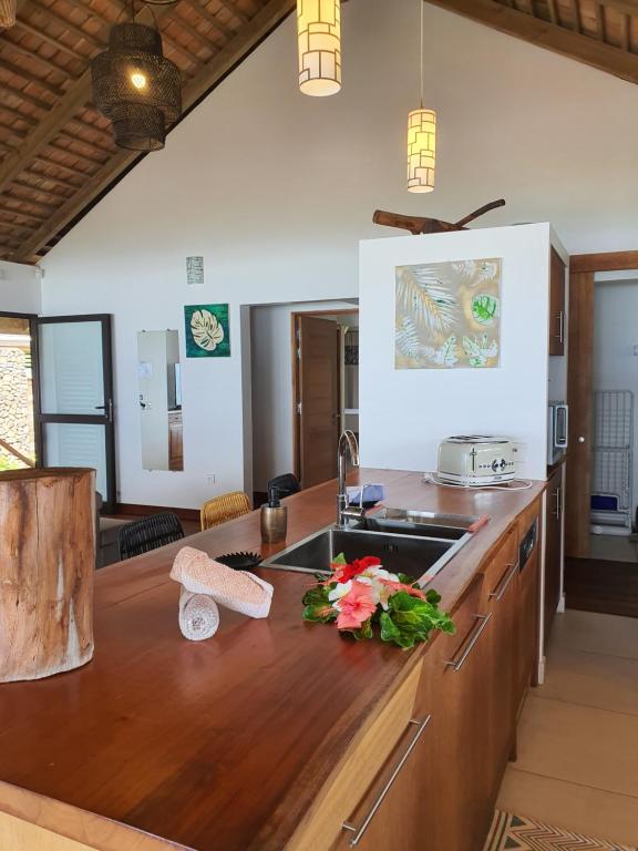a kitchen with a wooden counter top with a sink at Moorea Lodge Bungalow in Temae