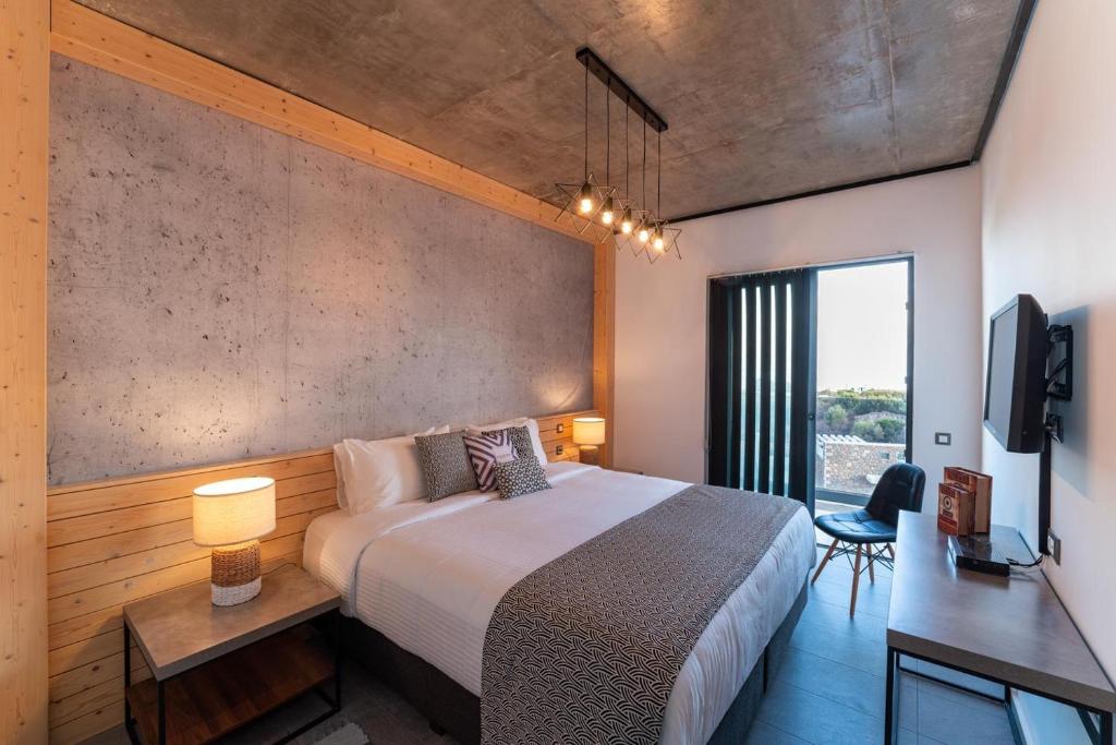 sypialnia z dużym łóżkiem i dużym oknem w obiekcie amara luxury villas w mieście Lakhania