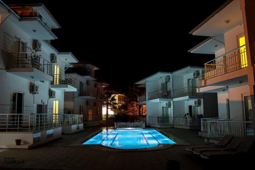 a swimming pool in a courtyard between two buildings at Sarıgerme Apart in Sarigerme