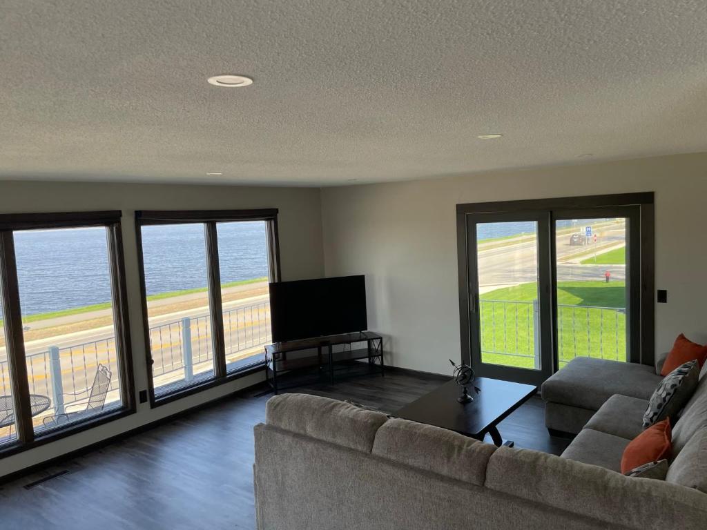 a living room with a couch and a flat screen tv at 3 Bedroom Condo with Lake Pepin views with access to shared outdoor pool in Lake City