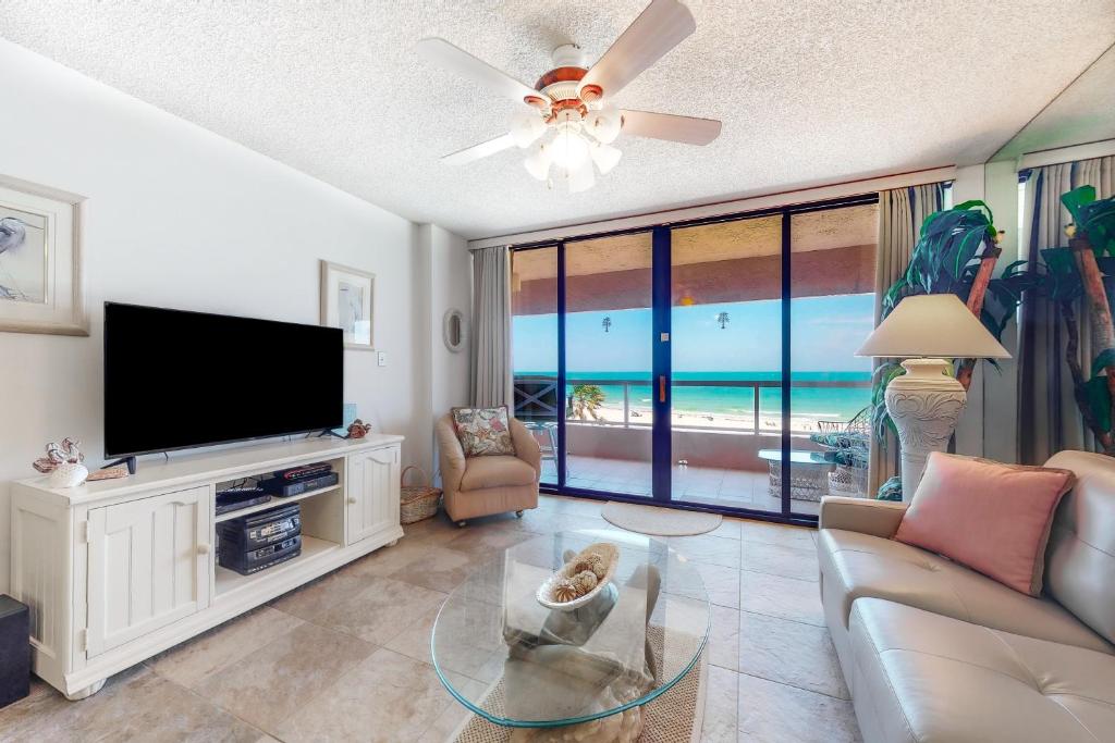 a living room with a flat screen tv and a couch at Crescent Beach Club I 5C in Clearwater Beach