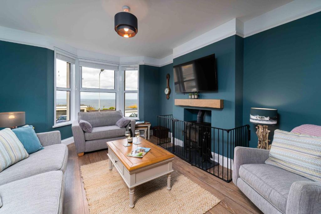 a living room with two couches and a tv at Porthmeor View in St Ives