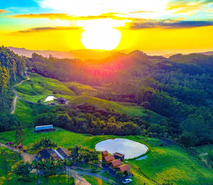 an aerial view of a golf course at sunset at Pousada Rio Túnel in Aiuré