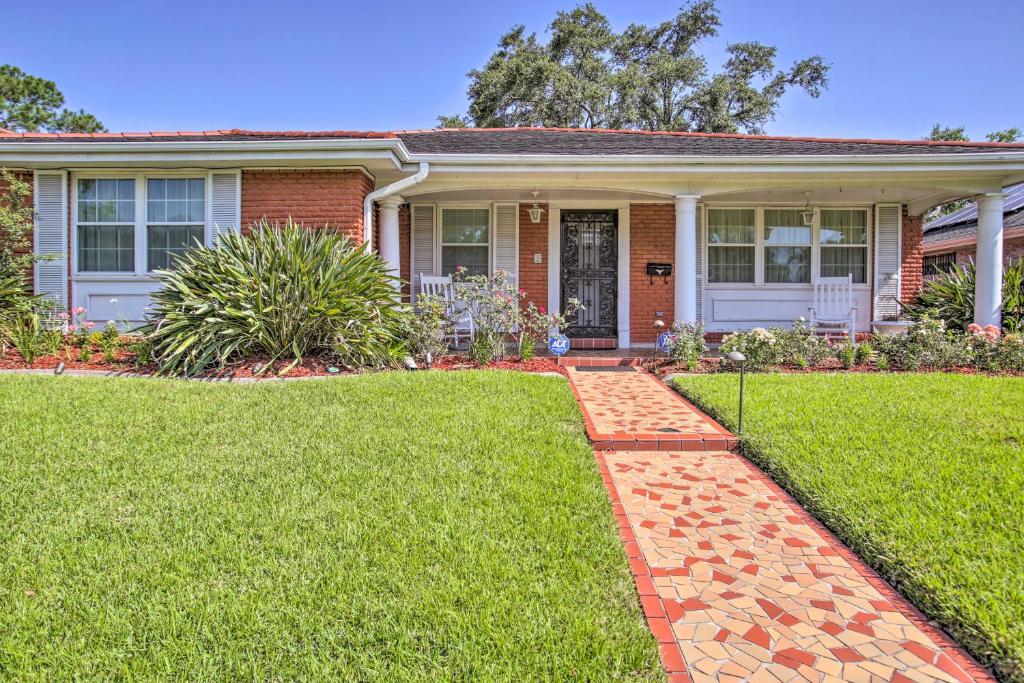 a brick house with a grass yard at New Orleans Getaway - 5 Mi to French Quarter! in New Orleans