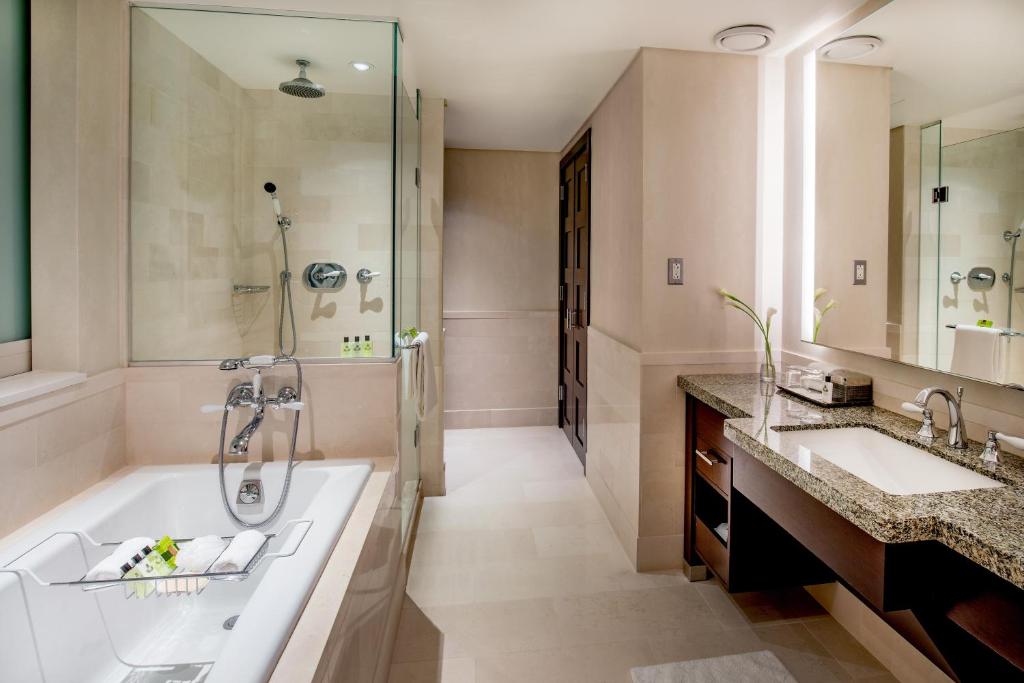 a bathroom with a tub and two sinks and a shower at InterContinental Boston by IHG in Boston