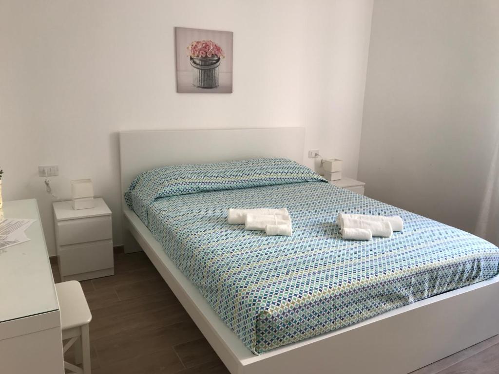 a bedroom with a bed with two pillows on it at Chioggia House di Marco in Chioggia