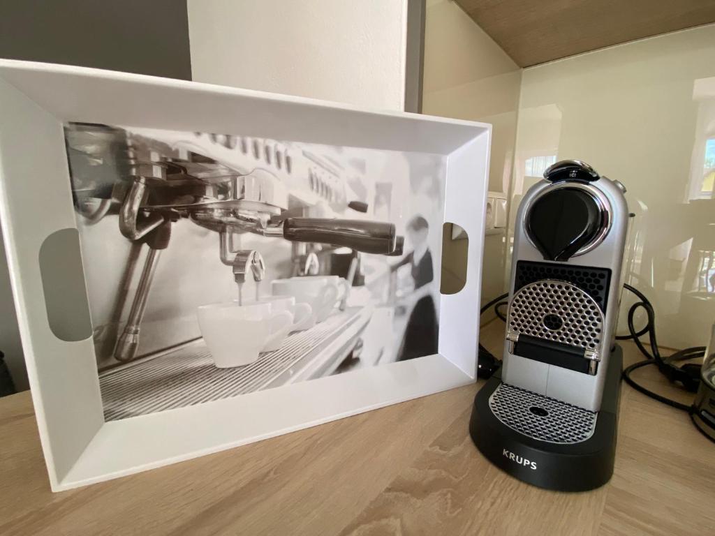 a kitchen mixer sitting on a counter next to a picture at Adria Villa Apartment family and friends in Velden am Wörthersee