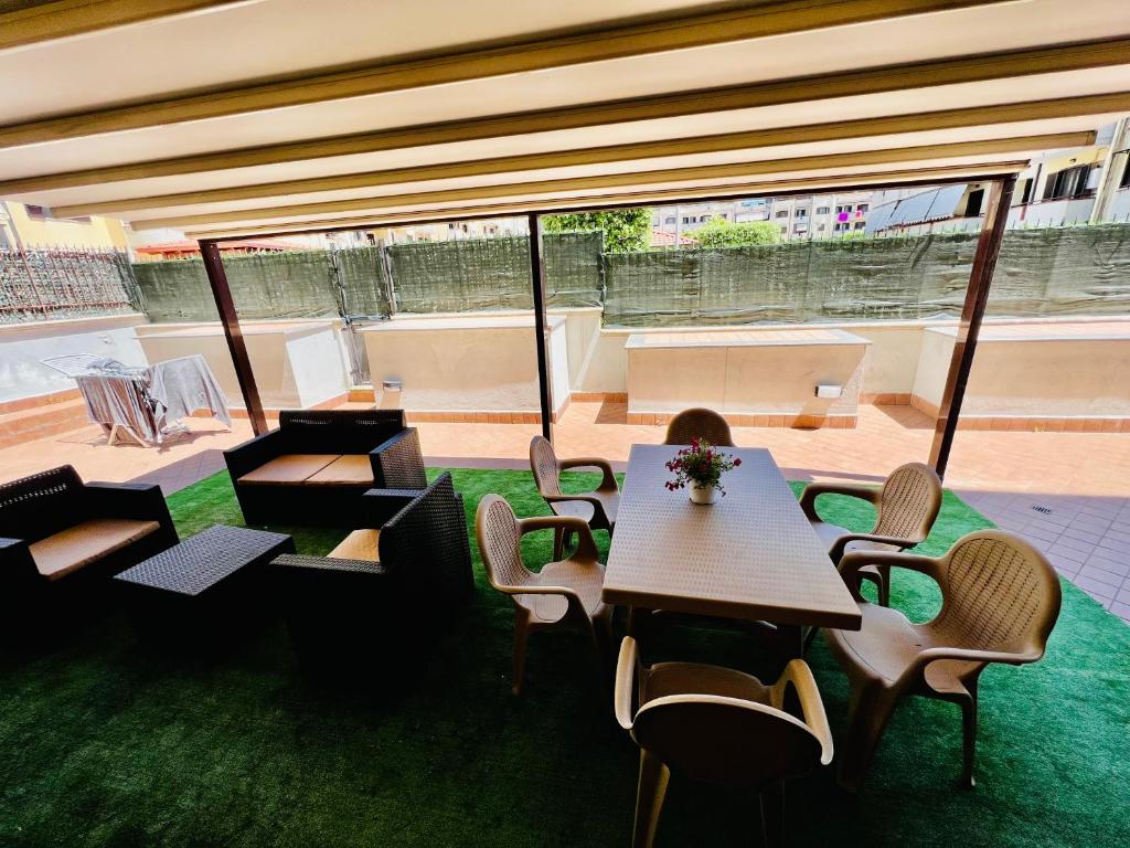 a room with tables and chairs and green grass at House of Mola in Naples