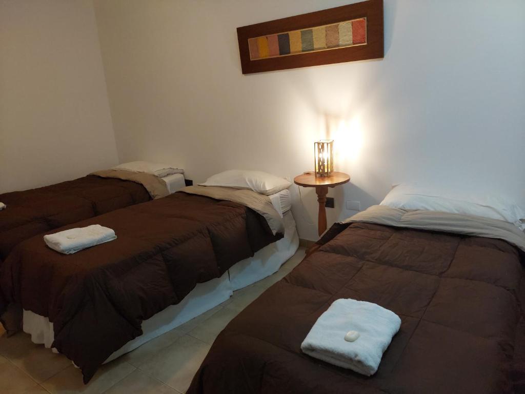 Postel nebo postele na pokoji v ubytování Hostal Tierra del Sol