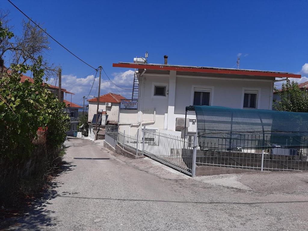 a white house with a fence in front of it at EFTHYMIOS Φθηνη και ησυχη διαμονη in Grammatikoú