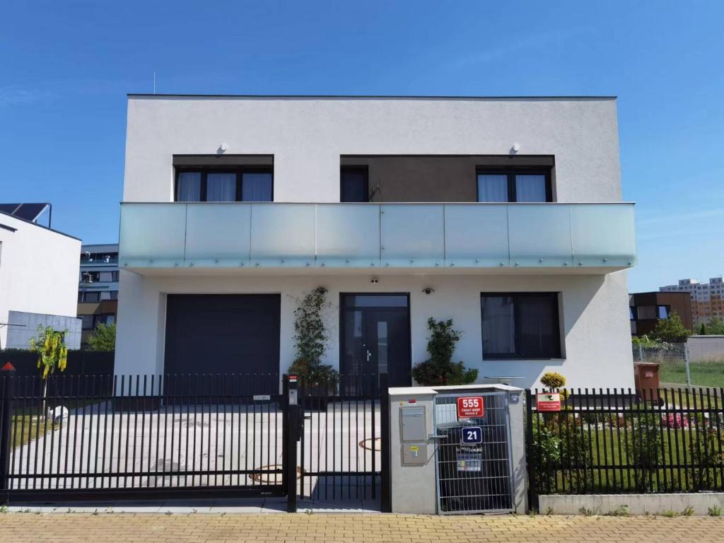 a white house with a parking meter in front of it at yipin villa in Prague