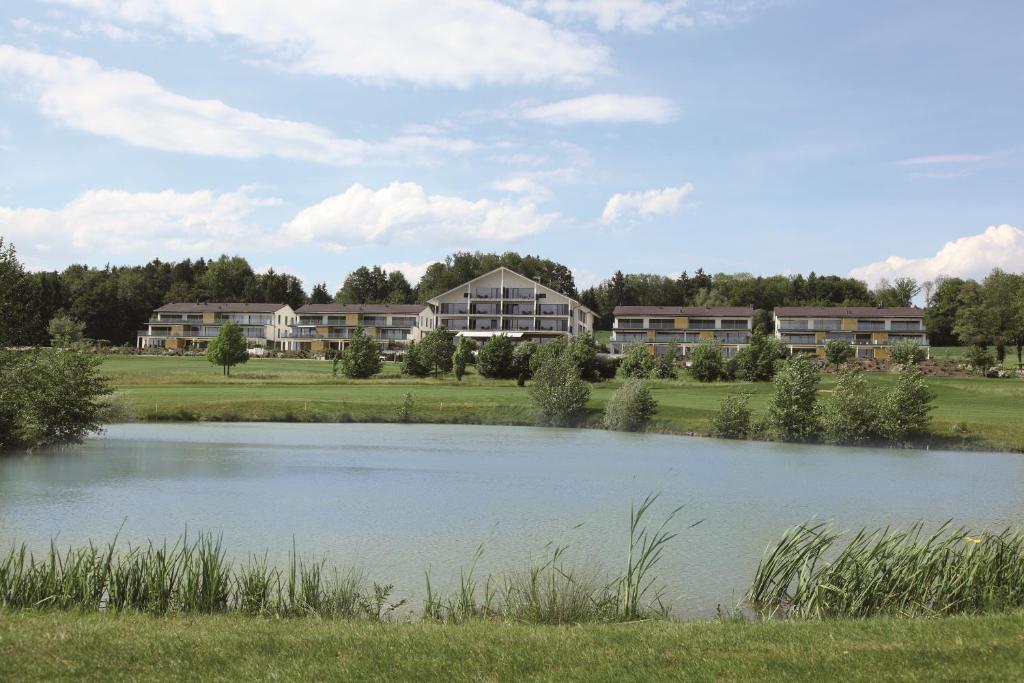 a large lake in front of a building at Wellnesshotel Golf Panorama in Lipperswil