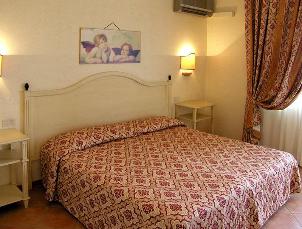 Postel nebo postele na pokoji v ubytování Hotel Santa Lucia Le Sabbie d'Oro