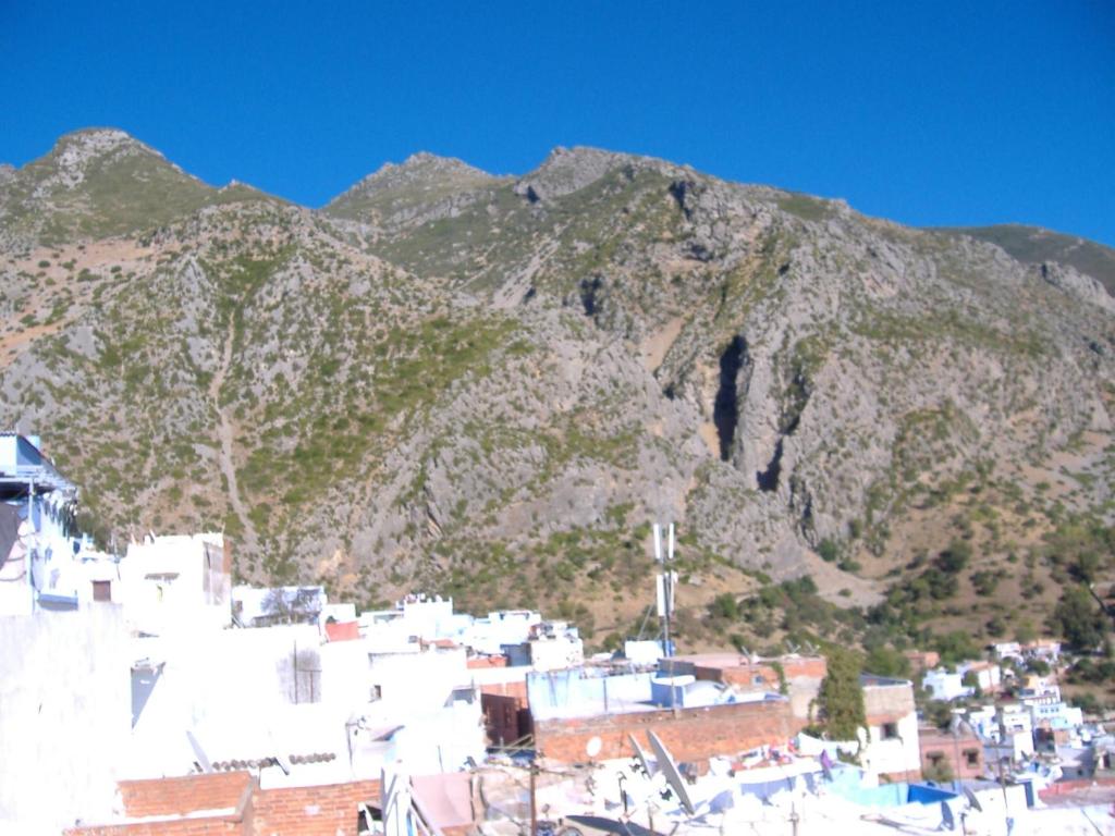 a view of a mountain with a town and buildings at Casa La Palma in Chefchaouene