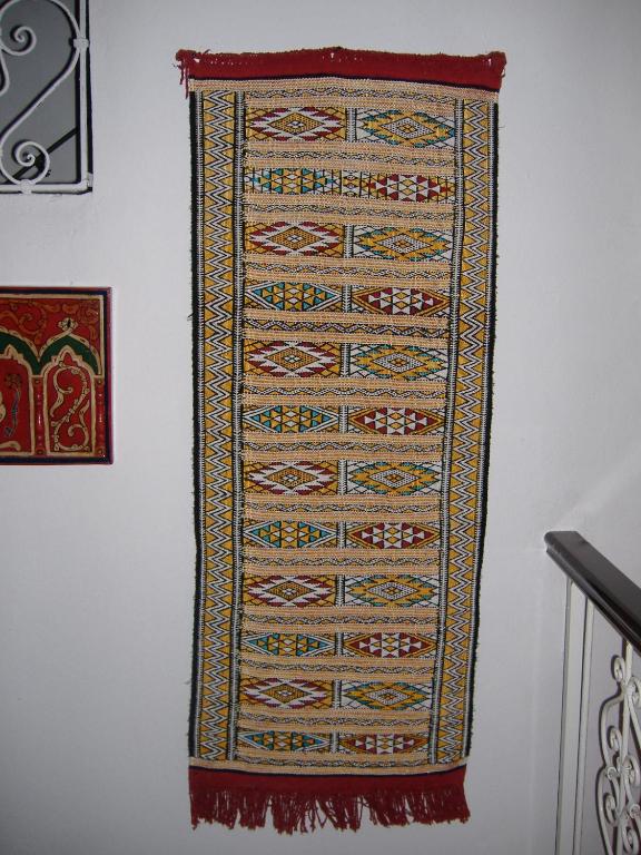 a tapestry hanging on a wall at Casa La Palma in Chefchaouene