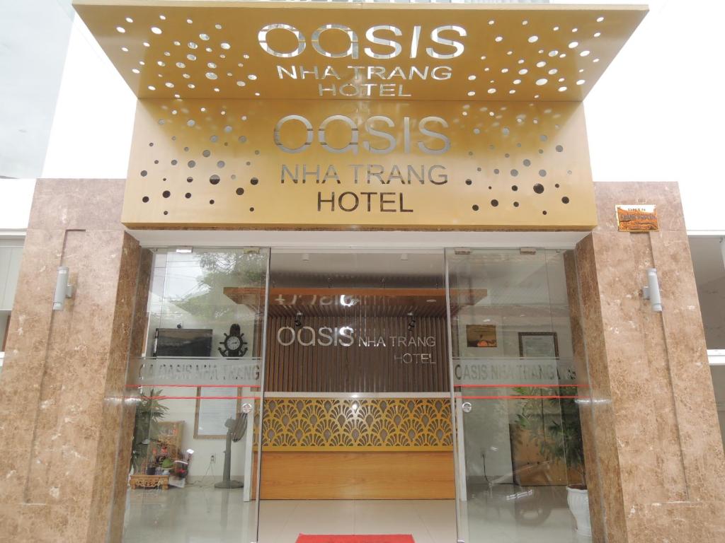 a building with a sign that reads oasisma tang hotel at Oasis Nha Trang Hotel in Nha Trang