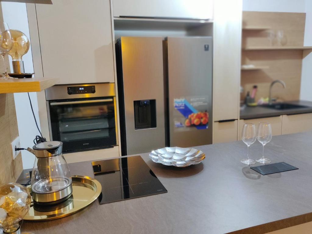 a kitchen with a counter with wine glasses on it at Vienna Top Apartment with Parking, great surroundings in Vienna