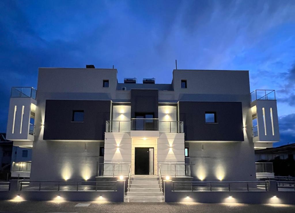 a large white building with lights on at Christina Suites in Flogita