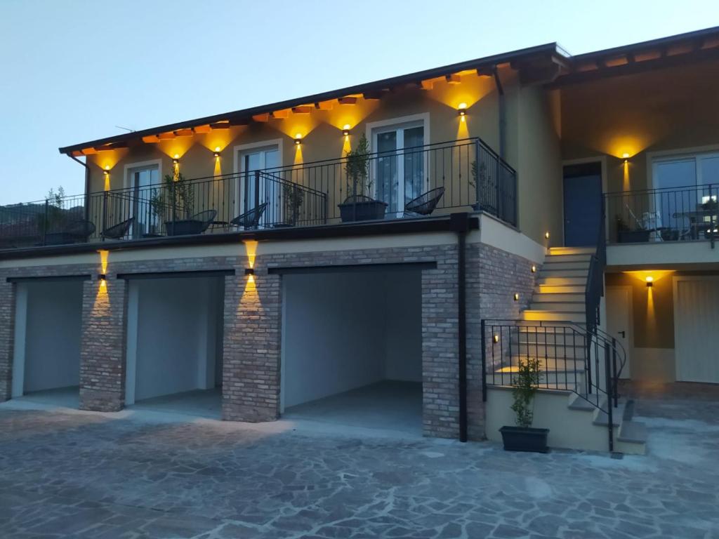 a house with two garage doors and a balcony at I Cappuccini wellness in Varzi