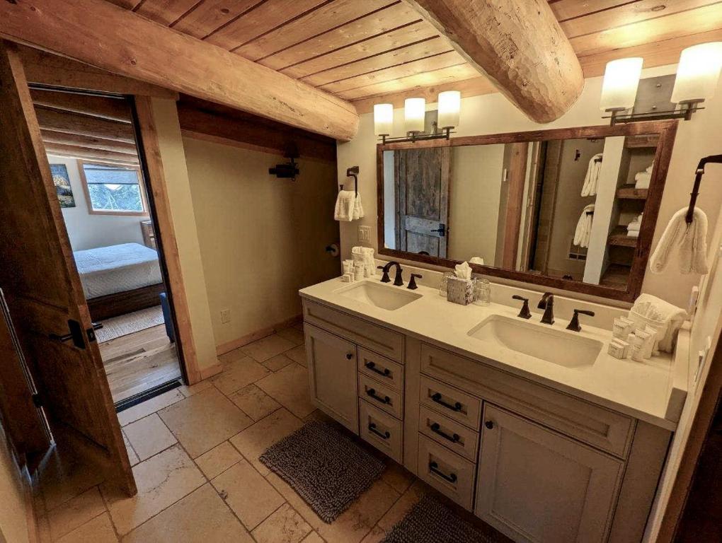 a bathroom with a sink and a mirror at Jackson Hole Hideout in Wilson