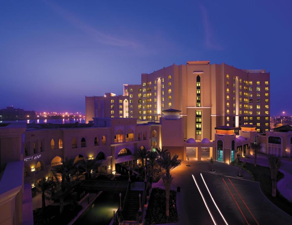 a view of a city at night with buildings at Traders Hotel, Abu Dhabi in Abu Dhabi