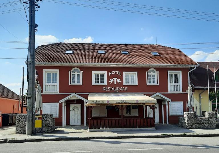 a red building on the corner of a street at Twins in Hurbanovo