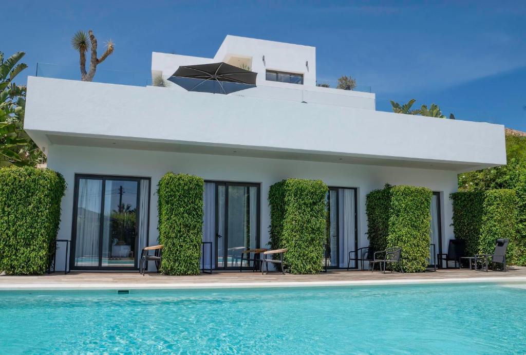 a villa with a swimming pool in front of it at Casa Bodhi Boutique Hotel & Spa in Marbella