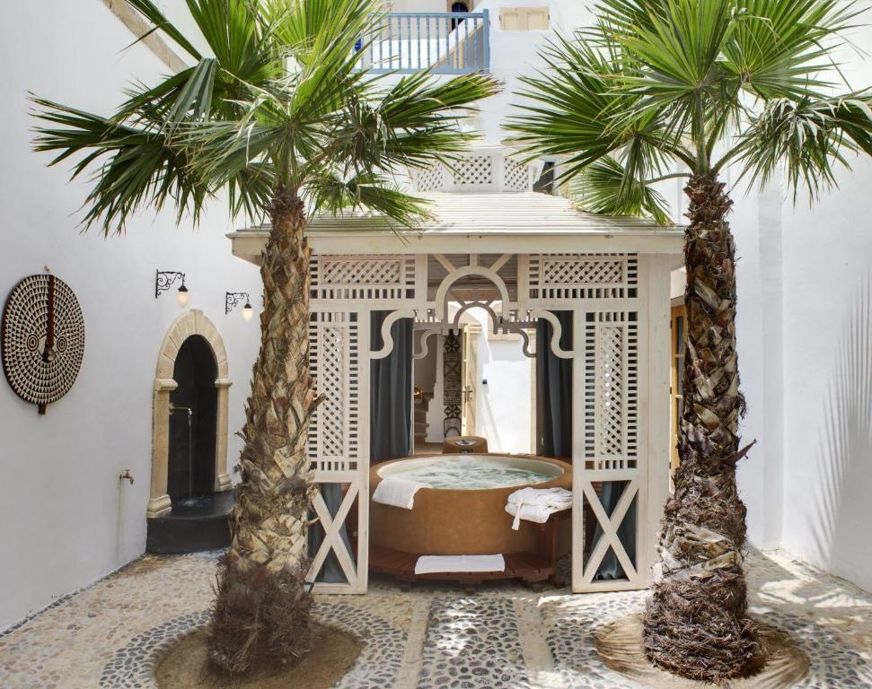 a large ornate room with a large clock on the wall at Riad Baladin in Essaouira