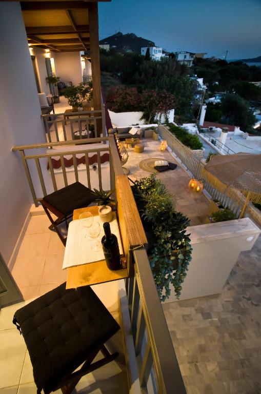 a patio with a table and chairs on a balcony at Horizon Hotel Kalymnos in Myrties