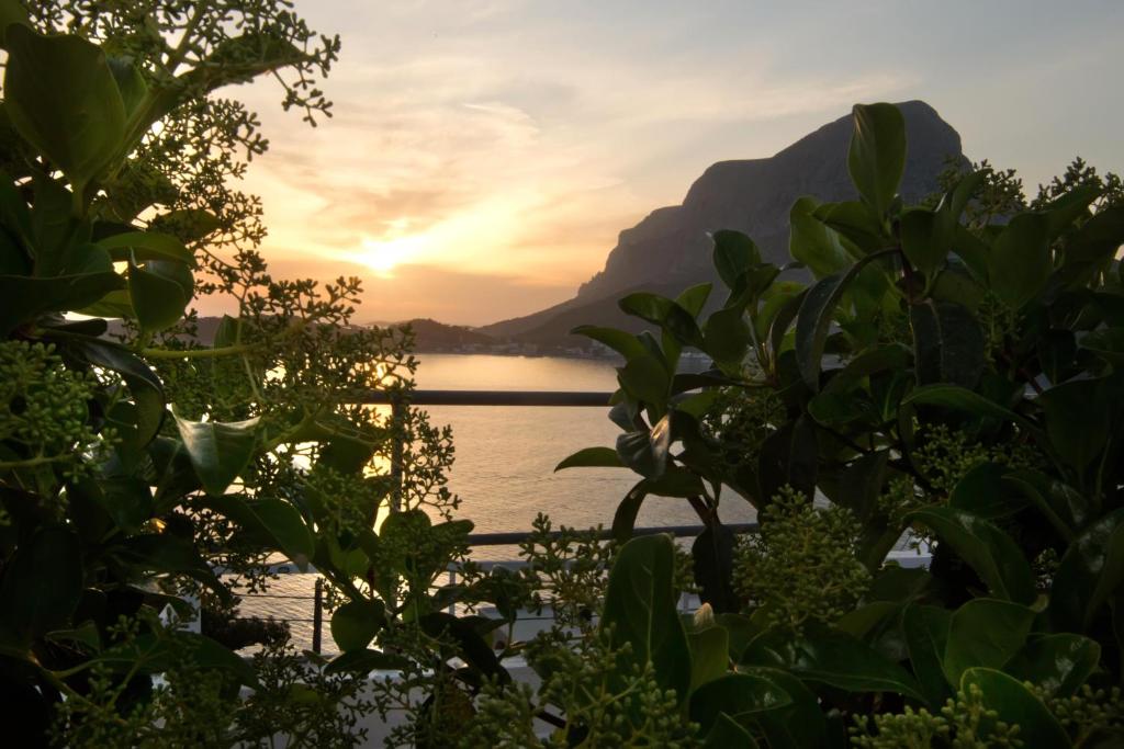 a view of a lake with a mountain in the background at Horizon Hotel Kalymnos in Myrties