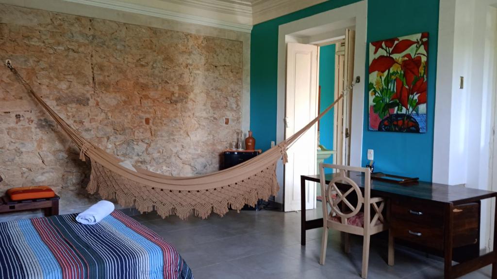 a bedroom with a hammock in the corner of a room at Chez Laurel in Rio de Janeiro