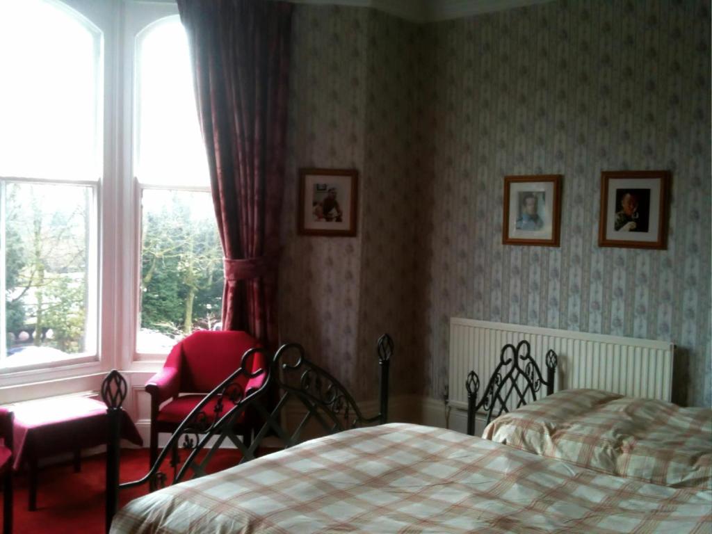 a bedroom with a bed and a window at Buckingham Hotel in Buxton