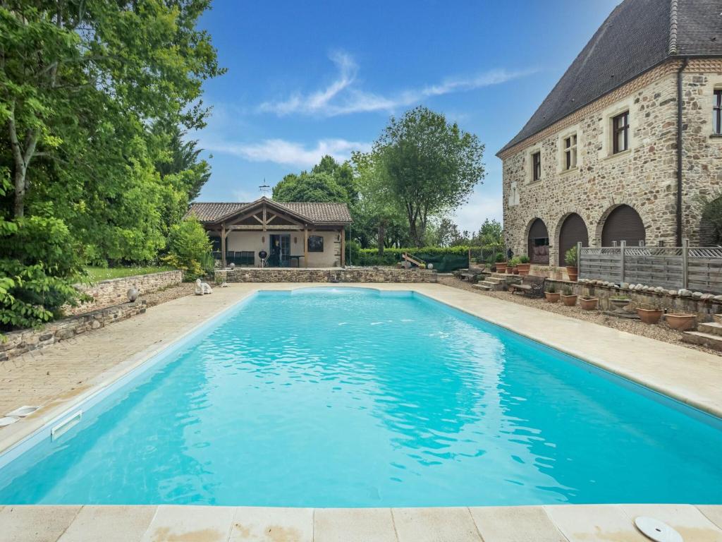 a swimming pool in front of a house with a building at Lively holiday home with private pool in Sainte-Trie