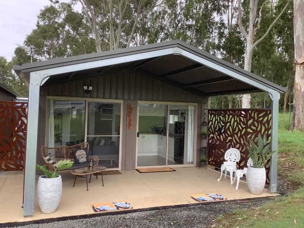 a pavilion with a table and chairs on a patio at Canungra Valley Views in Boyland