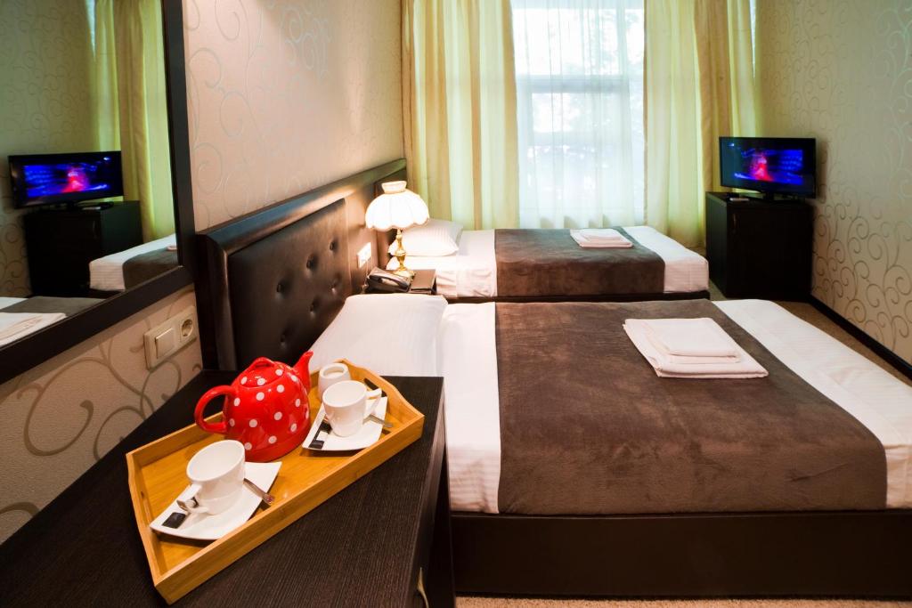 Postel nebo postele na pokoji v ubytování Kalasi Hotel