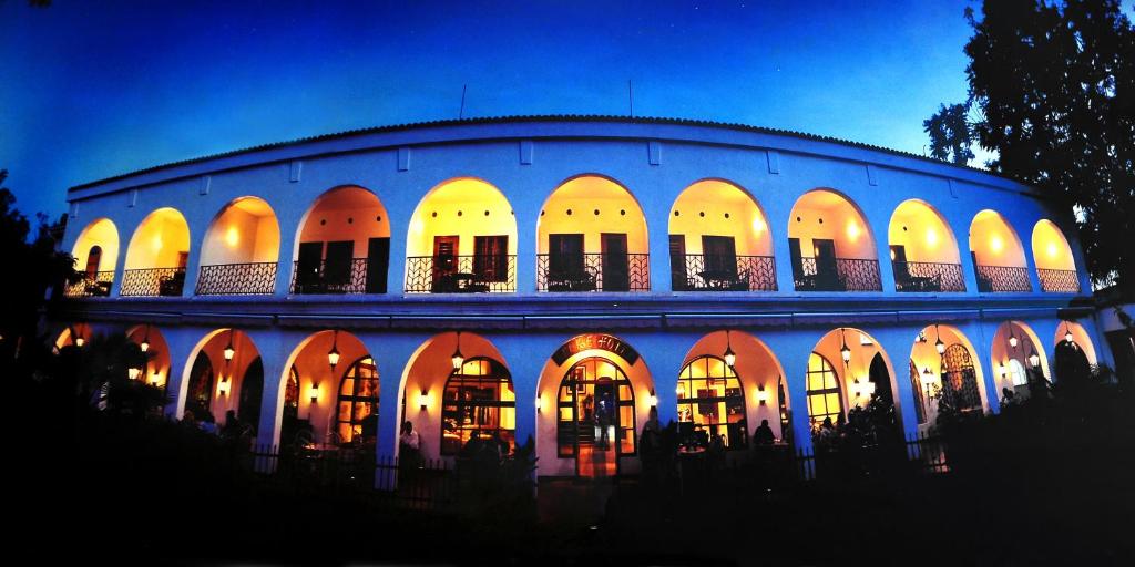 a large building with lights on it at night at Speke Hotel 1996 Ltd in Kampala