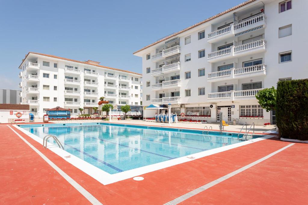 a large swimming pool in front of a building at Apt 200 meters from the beach id in Blanes
