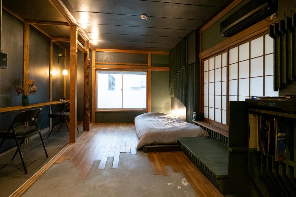 Postel nebo postele na pokoji v ubytování ローカル×ローカル