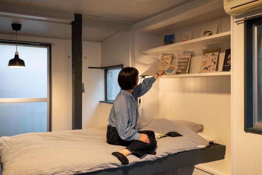 Postel nebo postele na pokoji v ubytování ローカル×ローカル