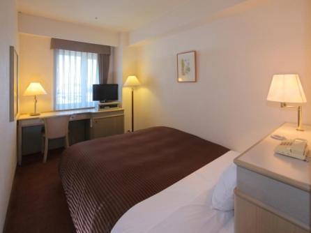 Postel nebo postele na pokoji v ubytování Hotel Green Tower Makuhari