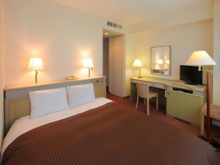 Postel nebo postele na pokoji v ubytování Hotel Green Tower Makuhari