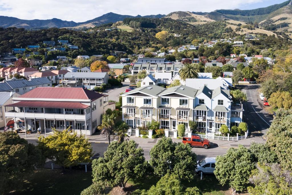 an aerial view of a town with mountains in the background at Bruce Waterfront Apartments in Akaroa