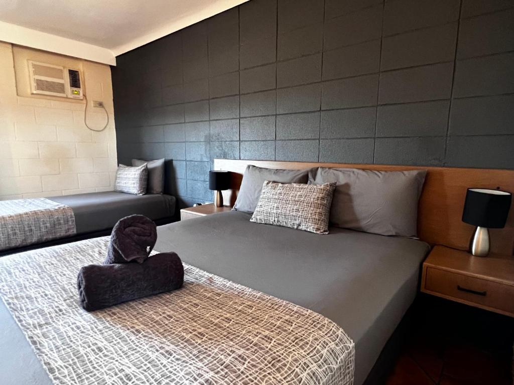 a hotel room with two beds at Hospitality Port Hedland in Port Hedland