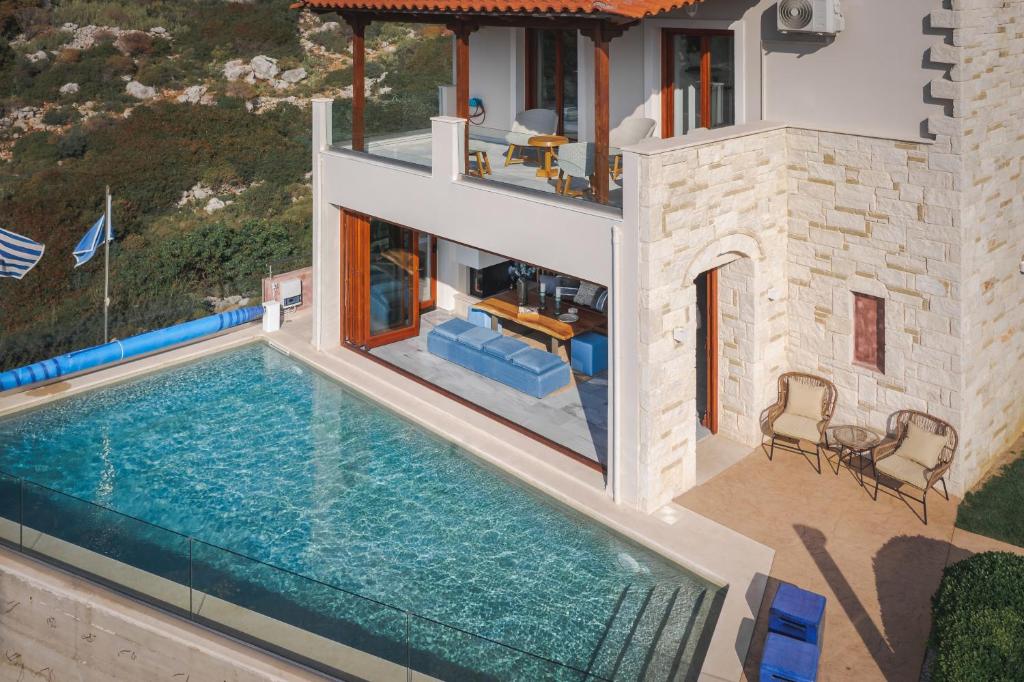 an aerial view of a house with a swimming pool at Villa Almy in Plaka