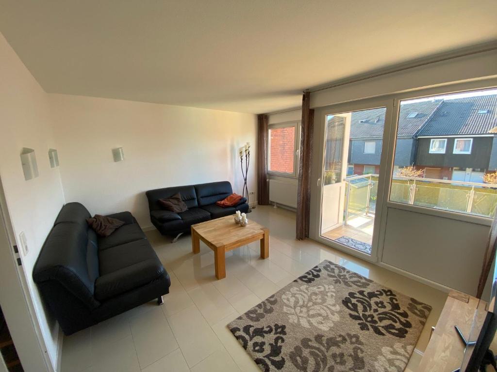 a living room with a couch and a table at Entspann you in Wangerland