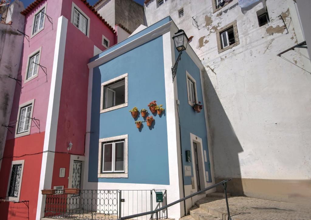 a mural on the side of a building at The Famous Blue House in Lisbon