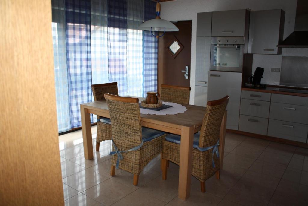 a kitchen with a wooden dining table and chairs at Apartment Charlotte in Neunkirchen