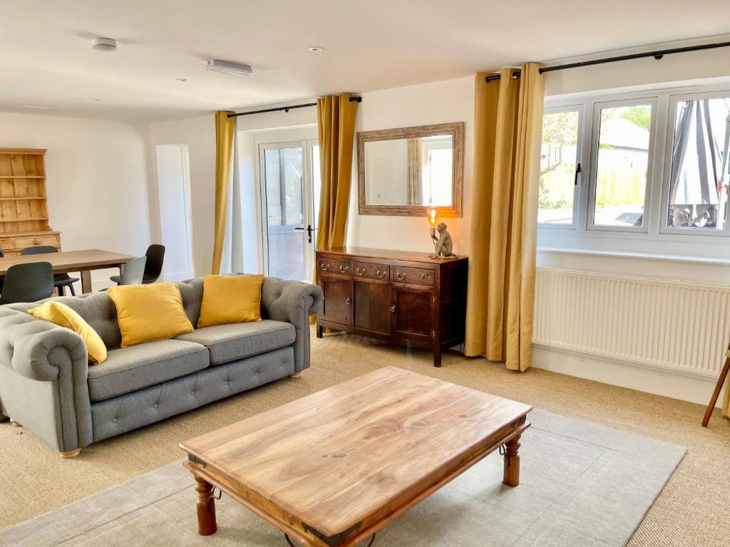 a living room with a couch and a coffee table at Rye Court Cottage - Stunning cottage in central Helmsley with parking in Helmsley